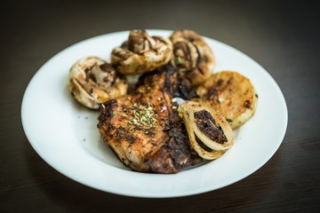 Grilled Steak, Mushrooms and Onion on the Plate on the Black