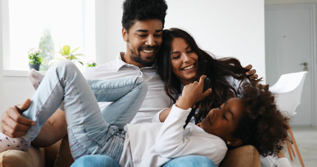 Happy family watching television at their home