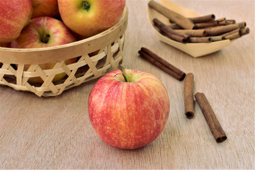 Ripe apples and cinnamon sticks, autumn harvest.