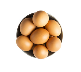 Eggs isolated on white background. Eggs isolated in wooden bowl . Close-up of an egg isolated on white background. Brown chicken eggs isolated on white.