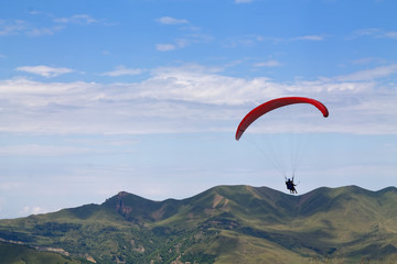Mountain parasailing, Skydiving flying over the mountains. parachute extreme sport