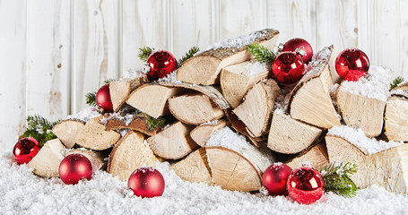 Winter stockpile of wood logs in snow at Xmas