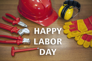 Business and industry concept.Labor Day is a federal holiday of United States America. Repair equipment and many handy tools. construction helmet, gloves, tools, inscription 