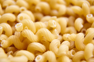 Heap of Uncooked Cavatappi Italian Pasta . Closeup, selective focus