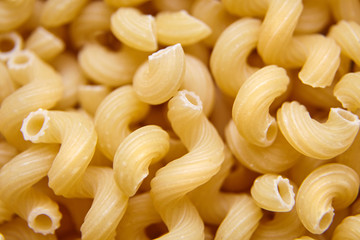 Heap of Uncooked Cavatappi Italian Pasta . Top view. Food Background
