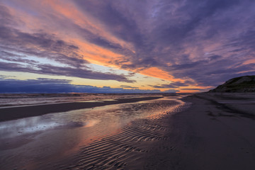 Fototapeta na wymiar Colorful the sea sunset with orange-violet paints