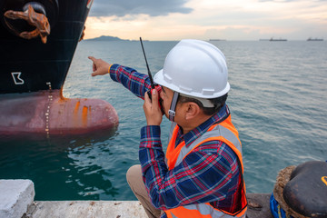 harbor master supervisor is survey and inspection of the safty berthing along side of the ship vessel mooring in port terminal, report and communication by radio walkie talkie