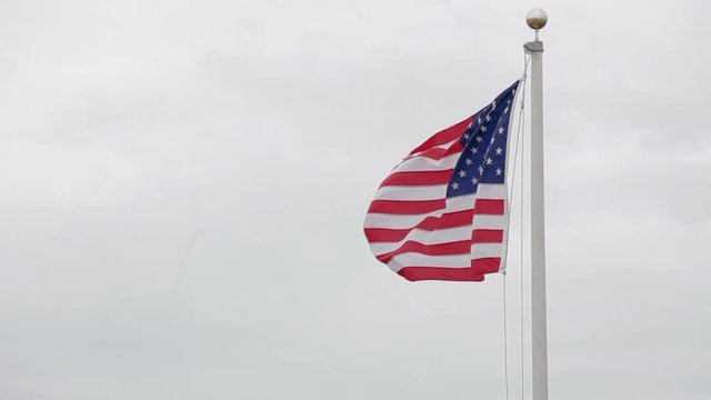 American flag on pole move left to right