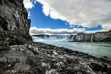 A waterfall in a beautiful rocky Iceland landscape.