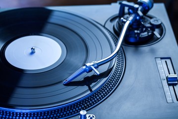 Close Up of Turntable Playing Vinyl in Blue Tone
