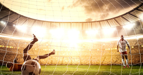 Intense soccer moment in front of the goal on the professional soccer stadium.