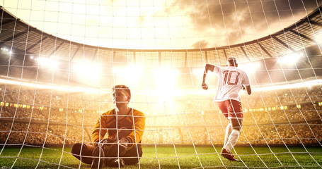 Intense soccer moment in front of the goal on the professional soccer stadium.