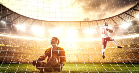Intense soccer moment in front of the goal on the professional soccer stadium.