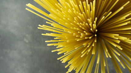 Yellow long spaghetti on a Rust stone background, Yellow italian pasta. Long spaghetti. Raw spaghetti bolognese, Food background concept,close up, Blank for design.
