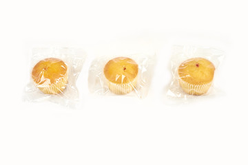 muffins packed in transparent packaging, on a white background.