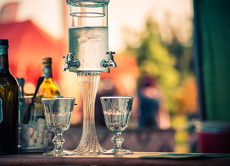 Classic ritual of glass of absinthe and dripping fountain - obrazy, fototapety, plakaty