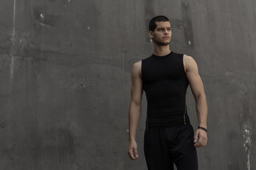 Fototapeta premium Sport model man posing gray wall background