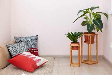 Photo of simple, minimal, wooden shelf, board, construction frame for two green plant flowers stand...