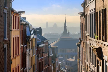 Zelfklevend Fotobehang Beautiful urban cityscape see through with a view over Liege, Belgium, from one of the street leading up the hill on a sunny winter morning © dennisvdwater