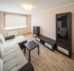 Interior of the flat. Warm tones, wooden floor. 