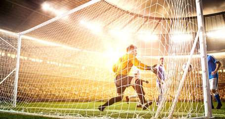 Intense soccer moment in front of the goal on the professional soccer stadium.