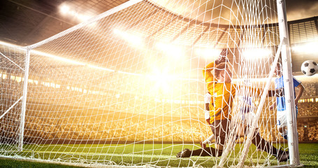 Intense soccer moment in front of the goal on the professional soccer stadium.