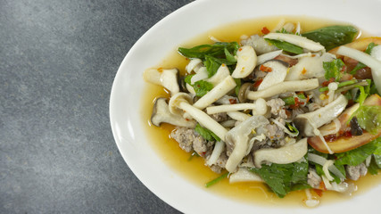 Thai food. Stir fried Fresh mushrooms with pork on rust stone background. Top view, Copy space for design. .