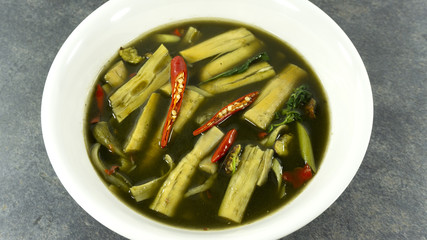 Thai food. Bamboo shoot soup on stone background. Top view, Copy space for design.
