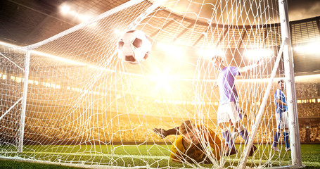 Intense soccer moment in front of the goal on the professional soccer stadium.