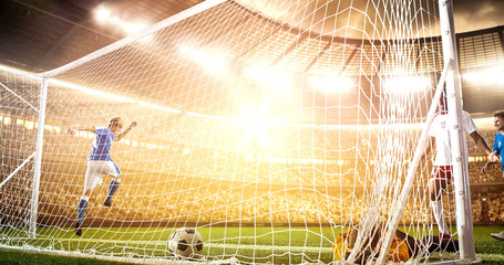Intense soccer moment in front of the goal on the professional soccer stadium.