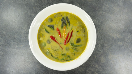 Thai food. Green Curry with Chicken on stone background. Top view, Copy space for design.