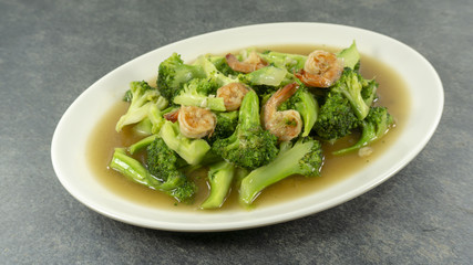 Thai food. Stir fried broccoli with shrimp on stone background.Top view, Copy space for design.