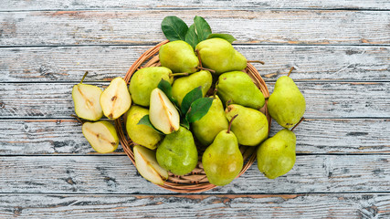 Fresh pears on a white wooden table. Fruits. Free space for text. Top view.