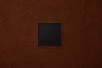 top view of gourmet cocoa powder with square copy space on black background