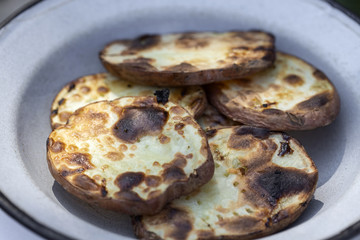 Slices of grilled potatoes on the plate