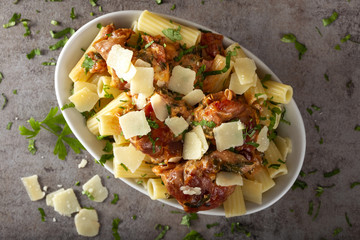 Chicen meat wrapped in prosciutto with tomato sauce and rigatoni pasta