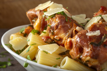 Chicen meat wrapped in prosciutto with tomato sauce and rigatoni pasta