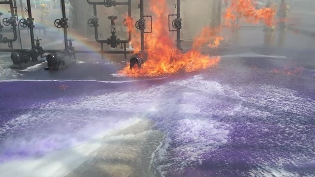 Purple Chemical Sprayed onto Fire during Training