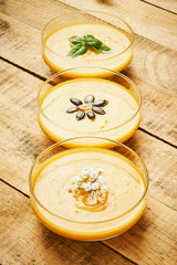fresh and delicious pumpkin soup on an old wooden kitchen table
