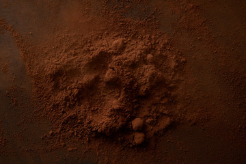 top view of delicious cocoa powder on dark background