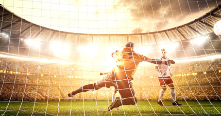 Intense soccer moment in front of the goal on the professional soccer stadium.