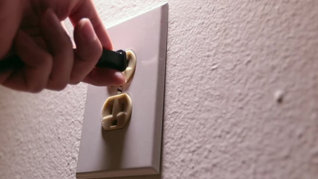 White outlet white wall side shadow lighting plugging chord in