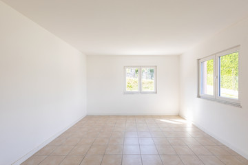 White empty room with tiles and windows