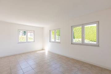 White empty room with tiles and windows