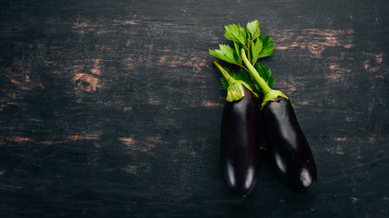 Eggplant. On a black wooden background. Free space for text. Top view.