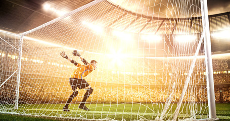 Intense soccer moment in front of the goal on the professional soccer stadium.