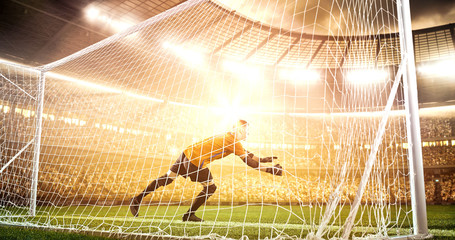 Intense soccer moment in front of the goal on the professional soccer stadium.