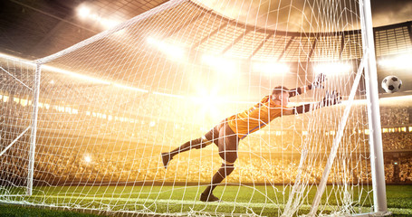 Intense soccer moment in front of the goal on the professional soccer stadium.