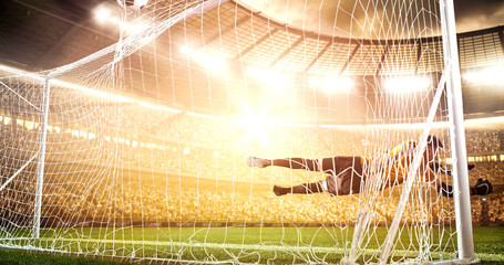 Intense soccer moment in front of the goal on the professional soccer stadium.