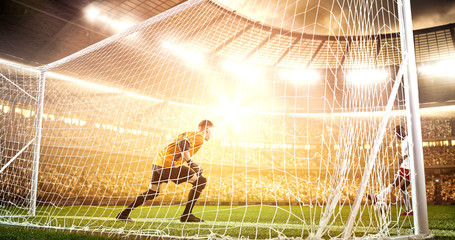 Intense soccer moment in front of the goal on the professional soccer stadium.